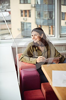 Smiling woman clothing designer sketching in office