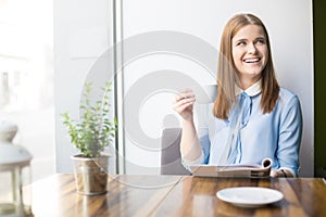 Smiling woman in coffee shop