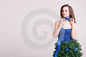 Smiling woman in conceptual christmas dress