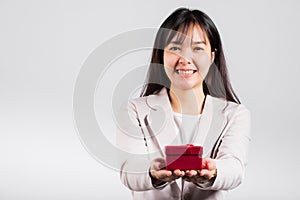 Smiling woman confidence holding red gift box on hands palm isolated white background