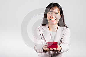 Smiling woman confidence holding red gift box on hands palm isolated white background