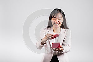 Smiling woman confidence opening a red gift box on palm isolated white