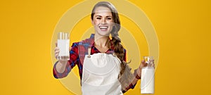 Smiling woman cook giving glass of homemade fresh raw milk