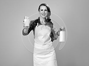 Smiling woman cook giving glass of homemade fresh raw milk