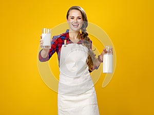 Smiling woman cook giving glass of homemade fresh raw milk