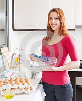 Smiling woman cooking omelet