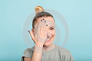 Smiling woman cover eye hand eyesight health check