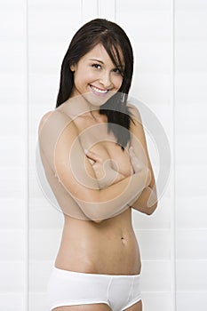 Smiling Woman Covering Breasts With Hands