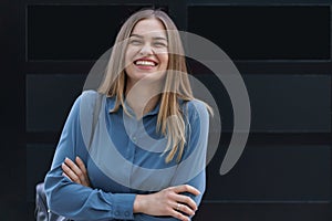 Smiling woman with crossed arms portrait