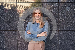 Smiling woman with crossed arms portrait