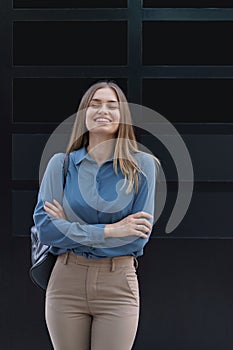 Smiling woman with crossed arms portrait