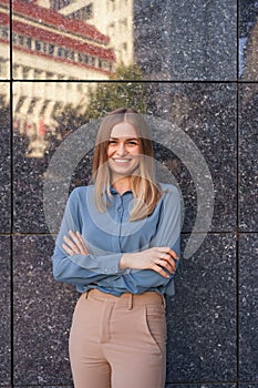 Smiling woman with crossed arms portrait