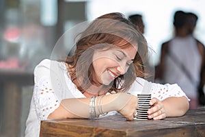 Smiling woman with a cup of drink