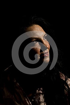 Smiling woman in darkness looking up