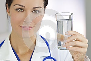 Smiling Woman Doctor Holding Glass of Water