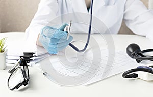 Smiling Woman doctor holds her stethoscope