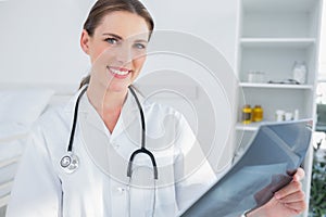 Smiling woman doctor holing a radiography