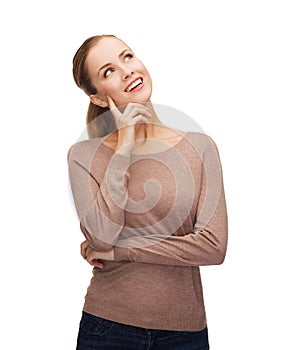 Smiling woman dreaming over white background