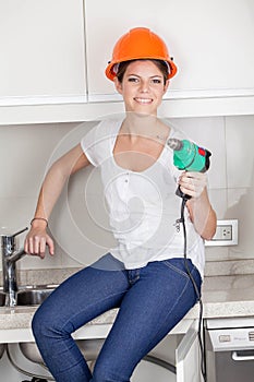 Smiling woman with a drill