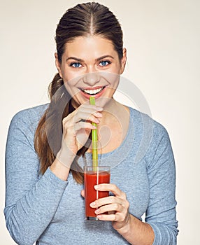 Smiling woman drink red juice.