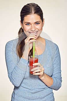 Smiling woman drink red juice.