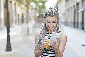 Smiling woman drinking fruit shake. photo