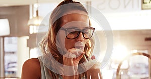 Smiling woman drinking milkshake