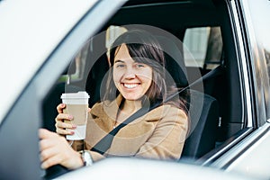 Smiling woman driving car. safety belt