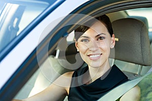 Smiling woman Driving Her Car