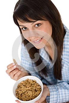 Smiling woman eat healthy cereal for breakfast