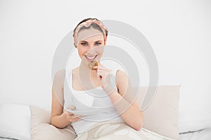 Smiling woman eating a biscuit