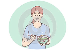 Smiling woman eating healthy vegetable salad