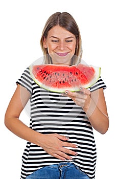 Smiling woman eating watermelon & holding her abdomen