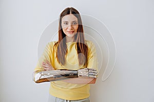 Smiling woman with elegant bionic prosthesis arm on grey