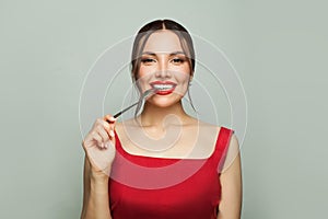 Smiling woman with empty fork on white background. Food temptation