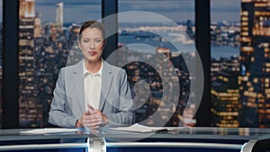 Smiling woman ending news late night on tv closeup. Evening program television