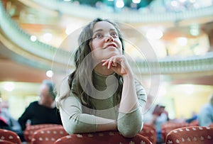 Smiling woman enjoying theatre performance