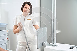 Smiling woman esthetician at workplace in aesthetic medicine clinic