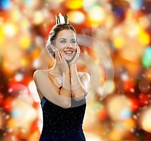 Smiling woman in evening dress wearing crown