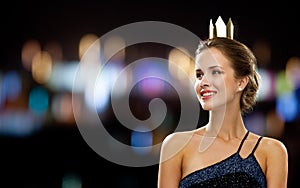 Smiling woman in evening dress wearing crown