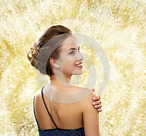 Smiling woman in evening dress wearing earrings