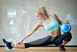 Smiling woman with exercise ball in gym