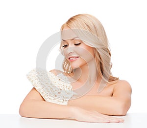 Smiling woman with exfoliation glove