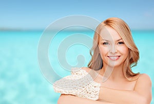 Smiling woman with exfoliation glove