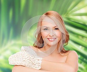 Smiling woman with exfoliation glove