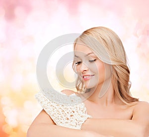 Smiling woman with exfoliation glove