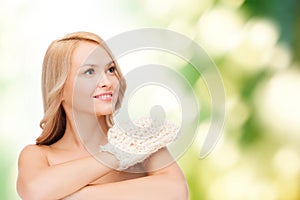 Smiling woman with exfoliation glove