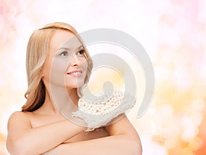 Smiling woman with exfoliation glove photo