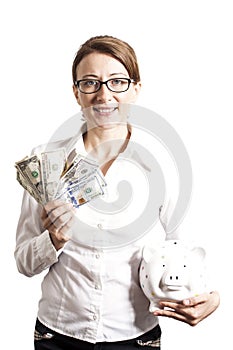 Smiling woman with eyeglasses holding piggy bank and dollars