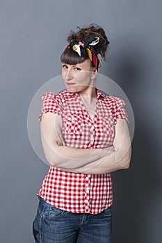 Smiling woman with fifties look posing and arms crossed